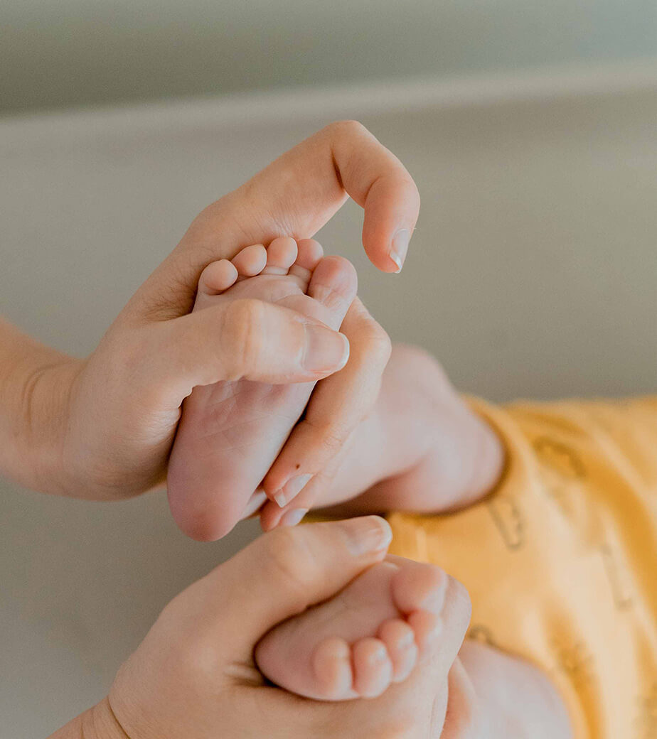 family films and photos: close-up of mum holding baby's foot