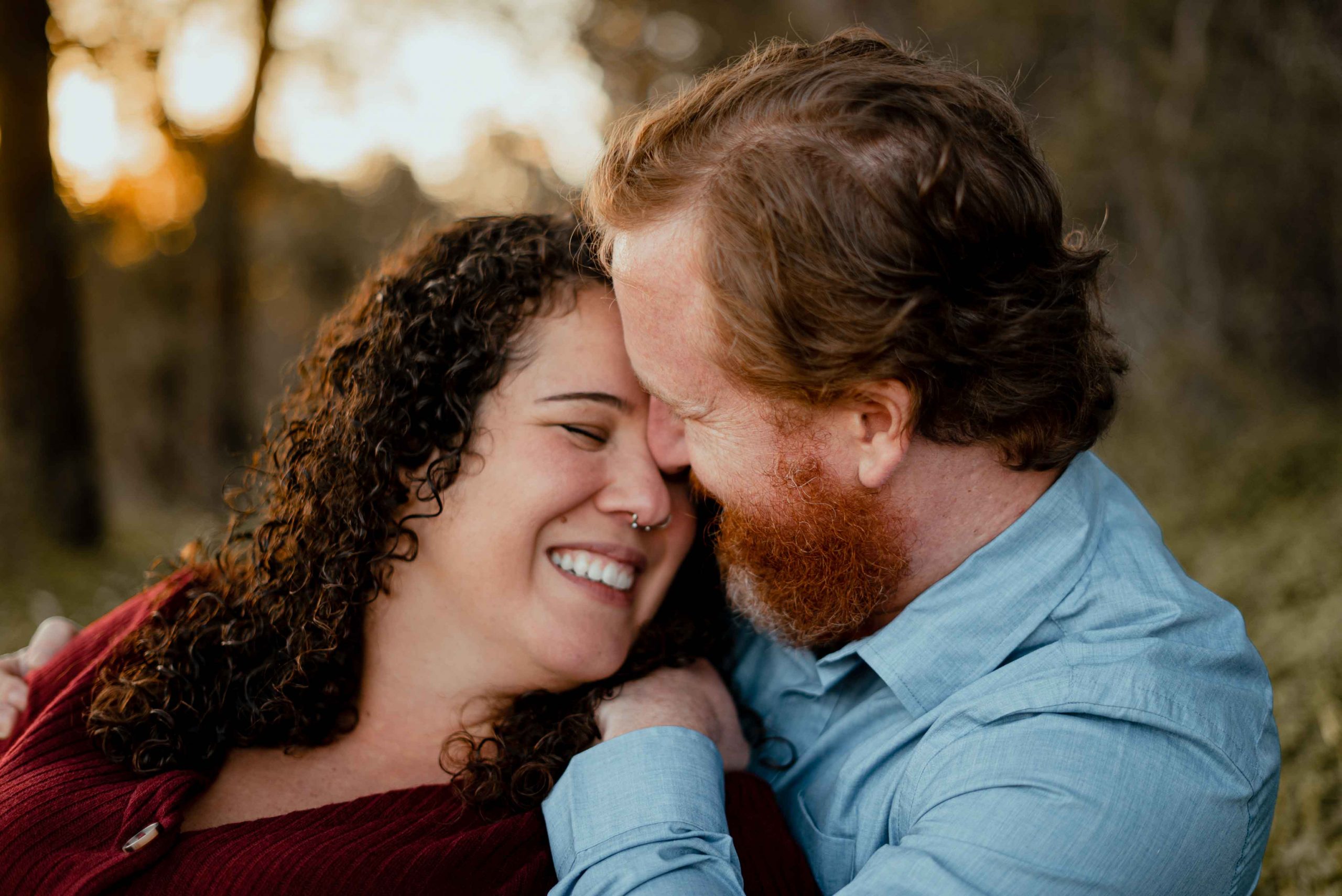 maternity films and photos: close up of couple touching faces and laughing naturally