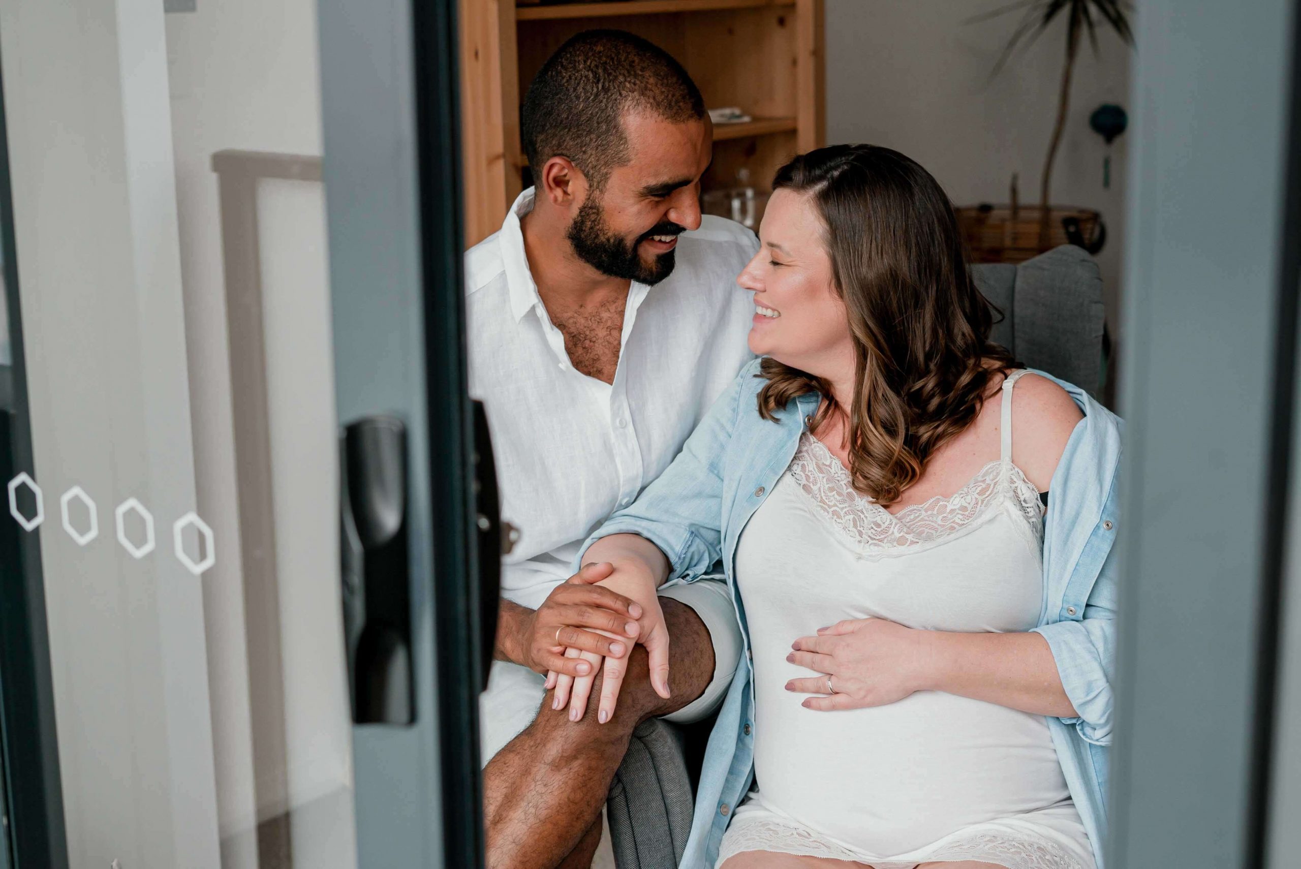 maternity films and photos: pregnant couple laughing at each other