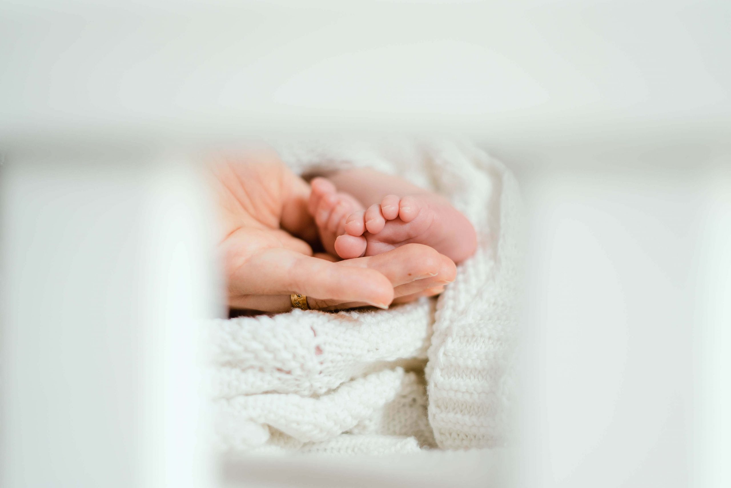 newborn films and photos: close up of mum holding newborn foot