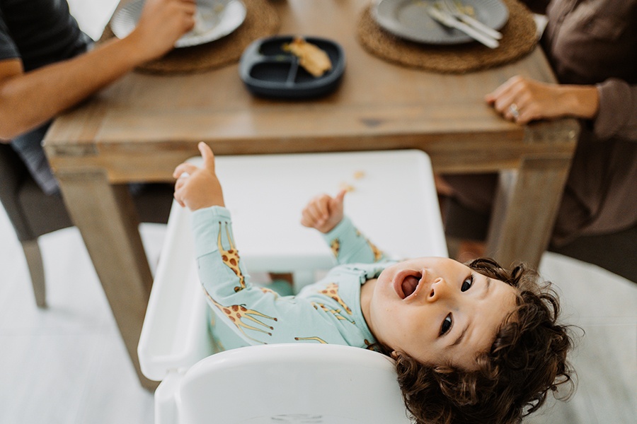 a family moment, child having breakfast with parents