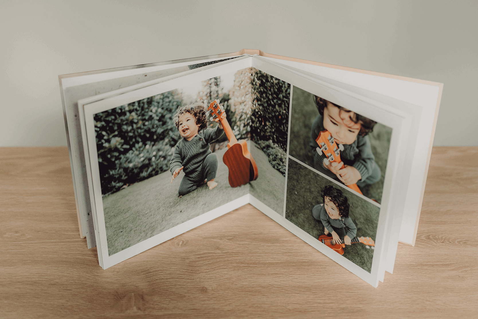 photoalbum open showing baby photos with a guitar