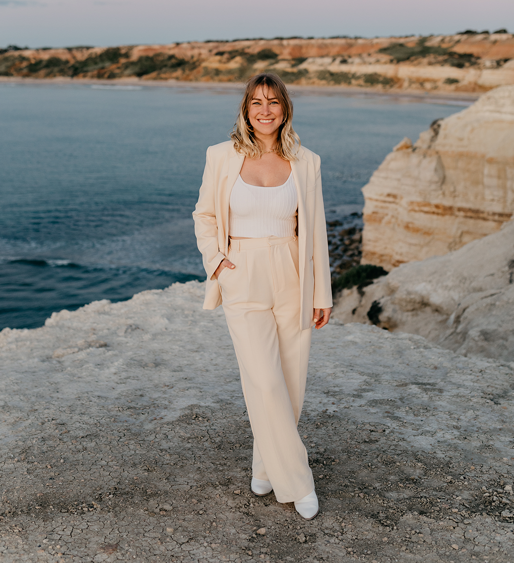 photo of vidographer and photographer in a stunning beach cliff view that looks like europe